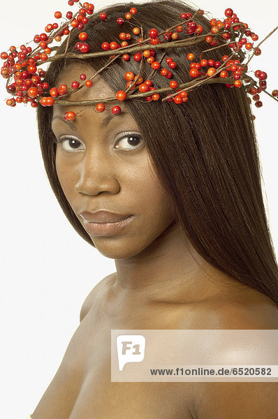 Young woman wearing crown of berries on her head
