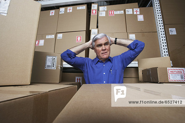Frustrated businessman in warehouse
