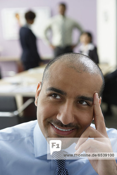 Middle Eastern businessman thinking