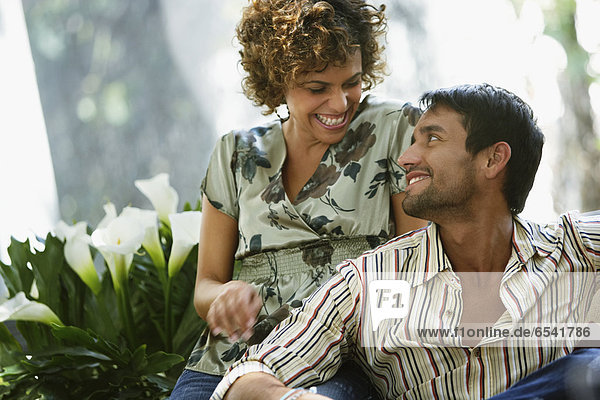 South American couple smiling at each other