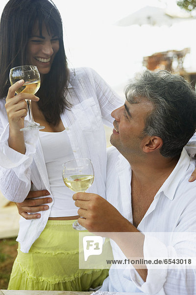South American couple drinking wine
