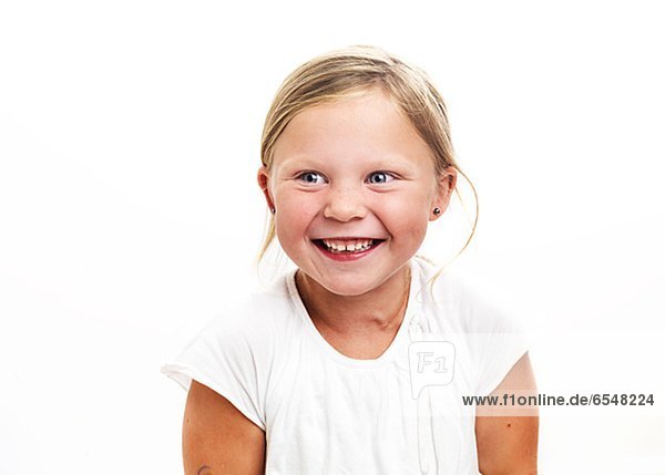 Portrait of smiling girl looking away  studio shot