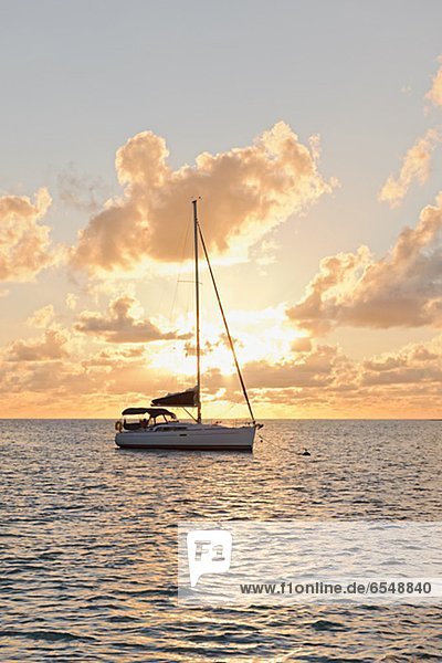 Sailing boat against sunset