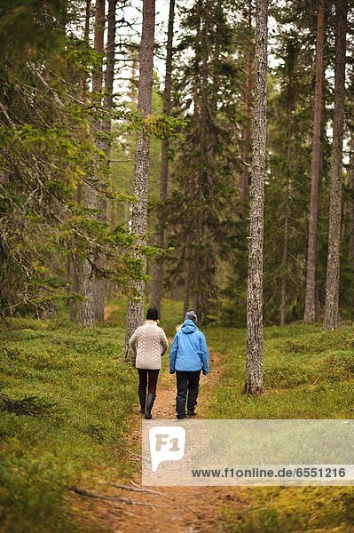 Two women waling through forest