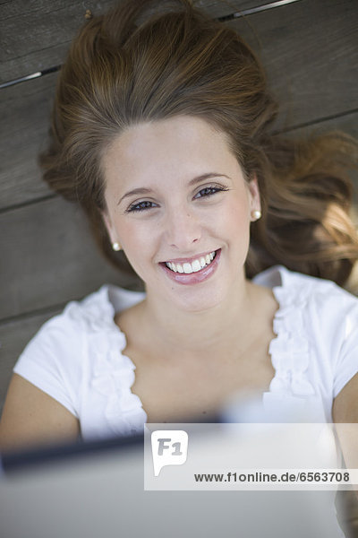 Europe  Germany  North Rhine Westphalia  Duesseldorf  Young student with touchpad  smiling  portrait