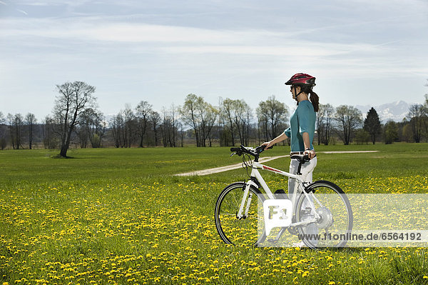 Mid adult woman riding electric bicycle