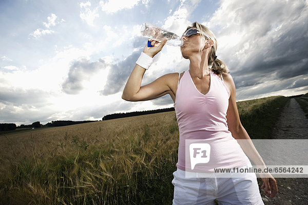 Mature woman drinking water