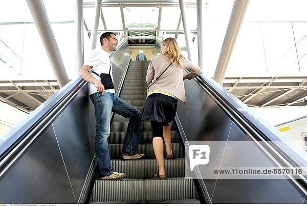 Young couple traveling by train. Young couple in the parking area of a station *** Local Caption ***
