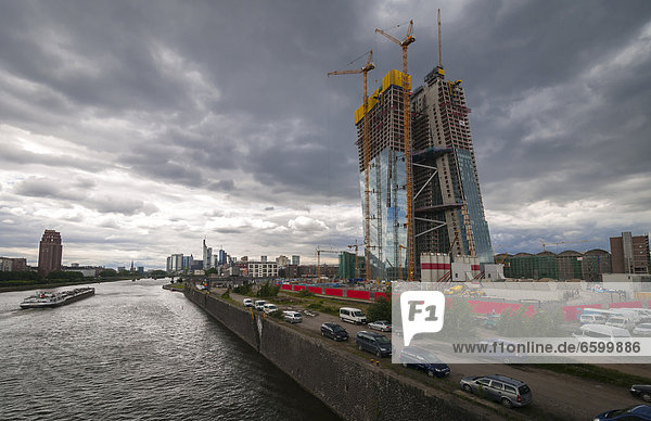 Construction site of the European Central Bank  ECB  with construction cranes on the site of the former central market hall  cargo ship on the Main river and Main Plaza building on the south bank of the Main river  Frankfurt am Main  Hesse  Germany  Europe  PublicGround