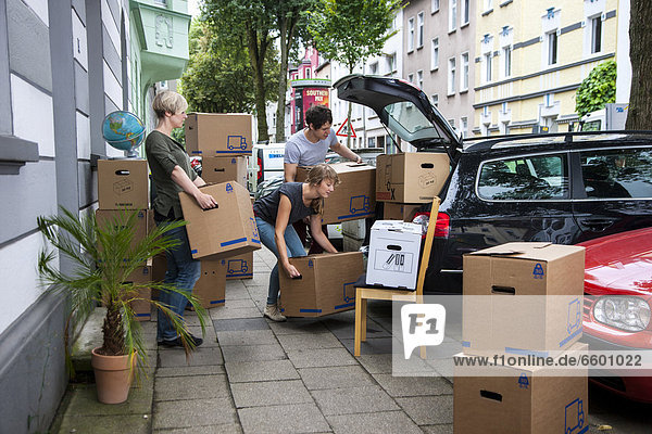 Private relocation  friends helping to load a car