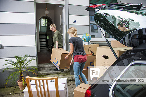 Private relocation  friends helping to unload a car