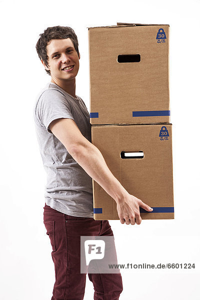 Young man carrying moving boxes