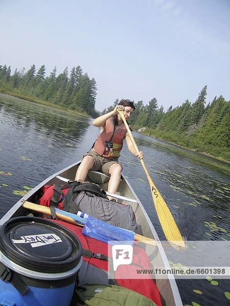 Woman Canoeing On A Boat In Algonquin National Park