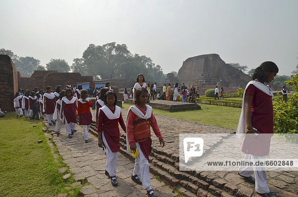 Indian pupils visiting the archaeological site and important Buddhist pilgrimage destination  the ruins of the ancient University of Nalanda  Ragir  Bihar  India  Asia