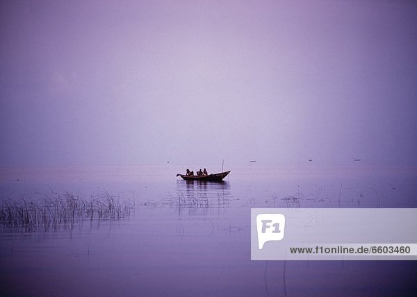 View Of A Boat In A Placid Lake.