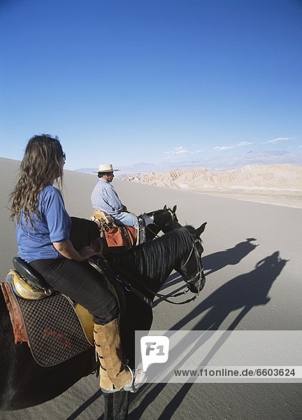 Couple Horse Riding In Valle De La Muerte