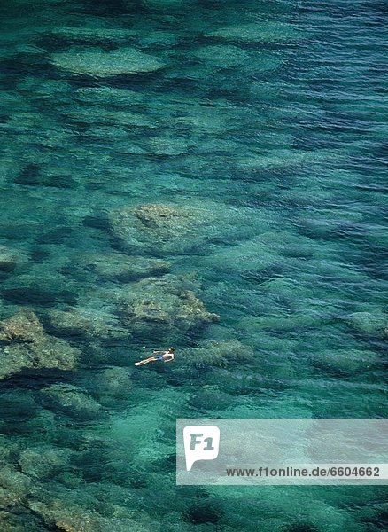 Man Swimming In The Sea Near Bonifacio
