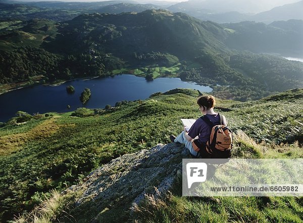 Walker Resting And Looking At Map Above Rydal Water