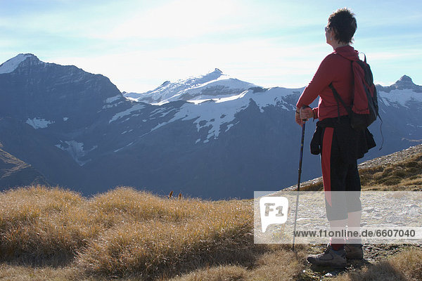 Hiker In Southern Alps Looking Over Mountains