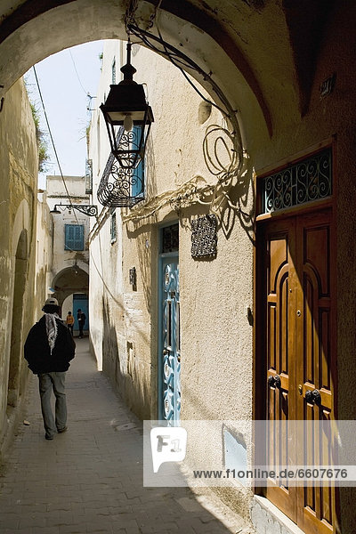 Man Walking Down A Back Alley In Medina