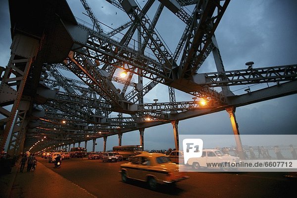 Taxis Going Over Howra Bridge In Calcutta At Dusk