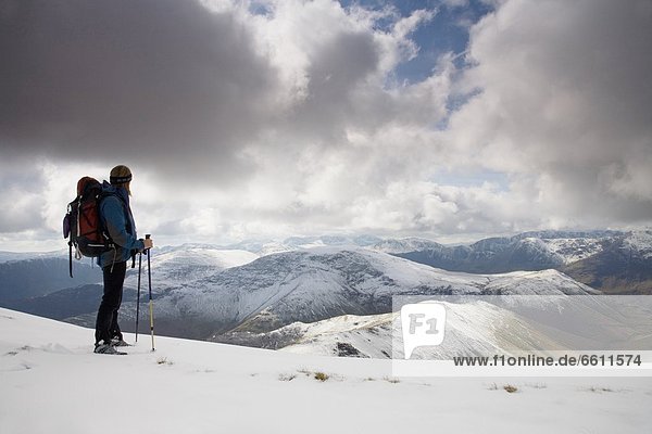 Hiker overlooking snow covered Newlands Valley