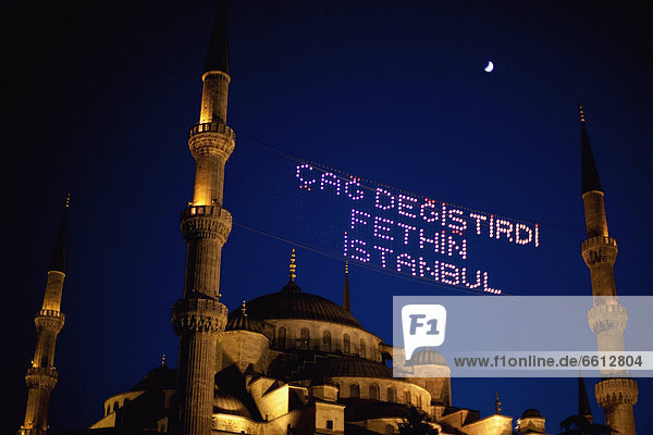 Blue Mosque at night with a lit sign