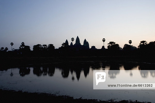Silhouette of Ankor Wat temple at dusk  Angkor Siem Reap Cambodia