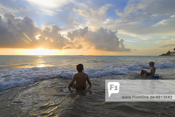 Children playing on beach at dusk  Treasure Beach Jamaica