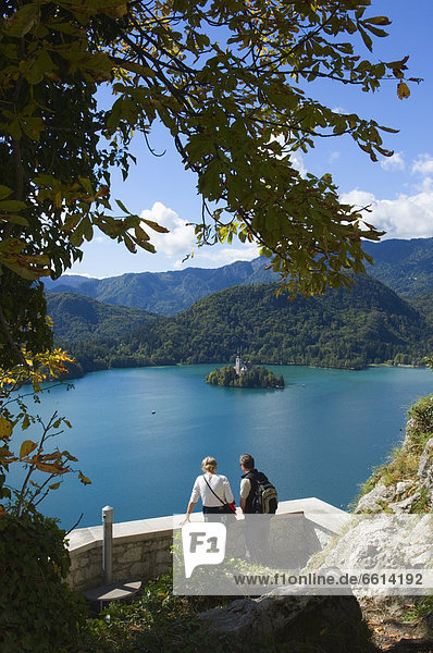 Two tourists looking at Lake Bled from castle  Slovenia