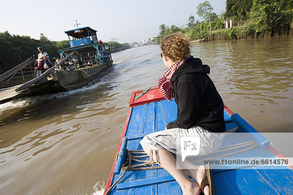 Young woman enjoying boat trip in Mekong Delta  Vinh Long Vietnam