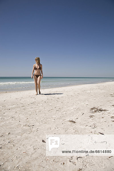 Woman walking on beach at Bean Point