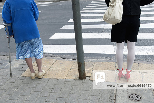 Two Women Of Different Generations About To Cross A Street In Warsaw  Poland ©David Potter / Axiom