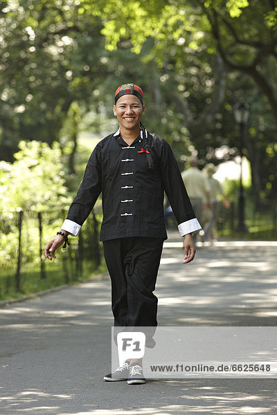Man in traditional Asian clothing walking in park