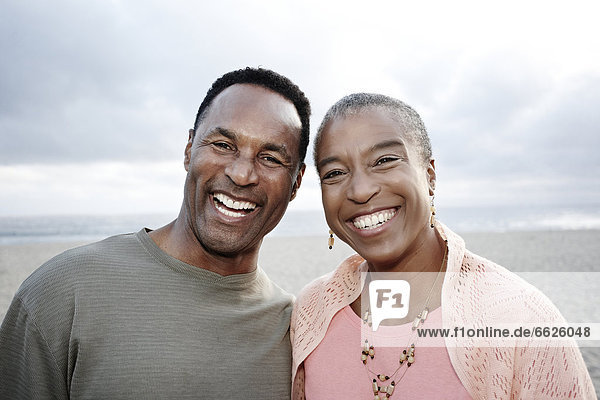 Smiling Black couple on beach