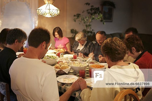 Family Praying Over Meal