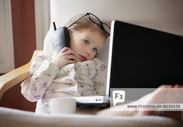 Child Working On Phone And Computer