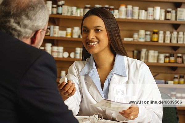 A Pharmacist With A Patient