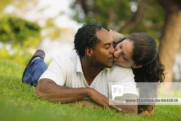 Couple Kissing In The Grass