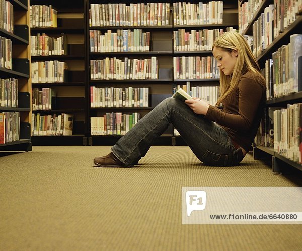 Girl Reading In A Library