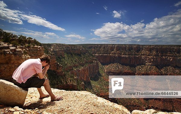 Man Praying At Grand Canyon