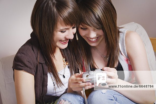 Two Teen Sisters Looking At Camera