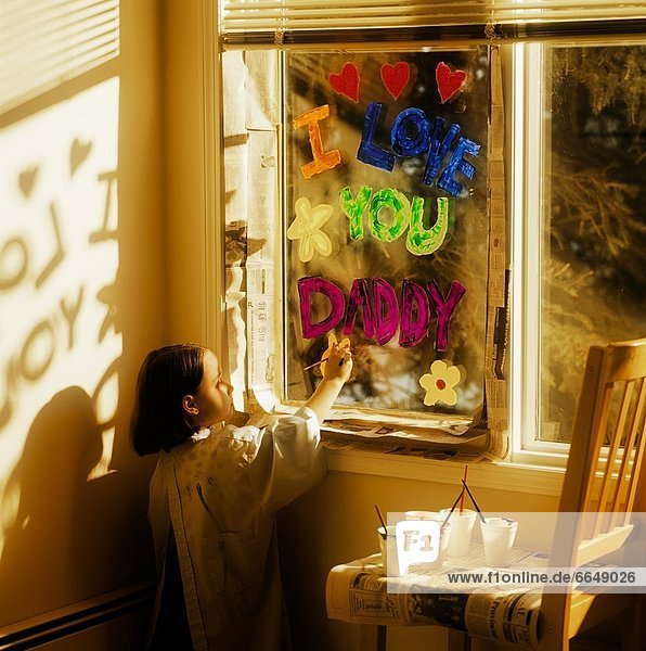 Little Girl Painting 'i Love You Daddy' On Window
