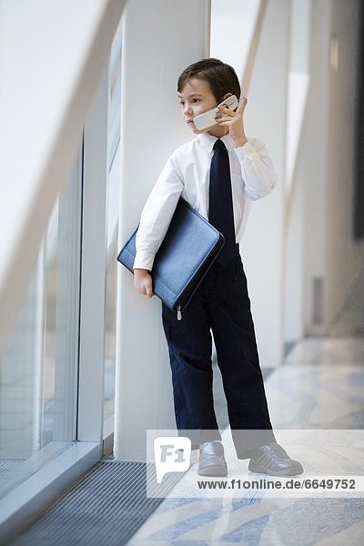 Boy Dressed Up Like Businessman And Talking On Cell Phone