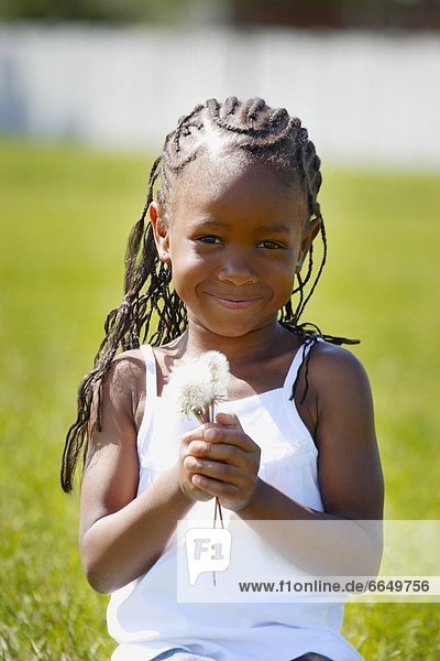 Young Girl Holding Dandelions