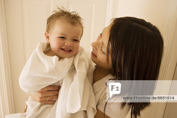 Mother Smiling And Holding Boy