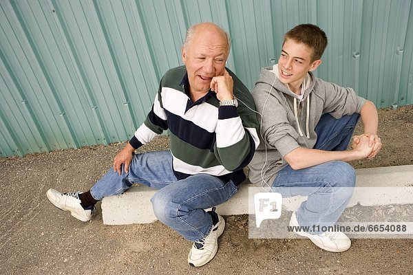 Grandpa And Grandson Listening To Music