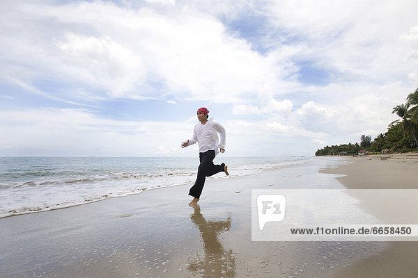 A Man Running Along The Beach