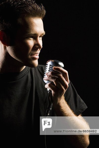 Man Singing In A Microphone