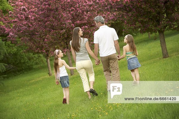 Family Walking In A Park